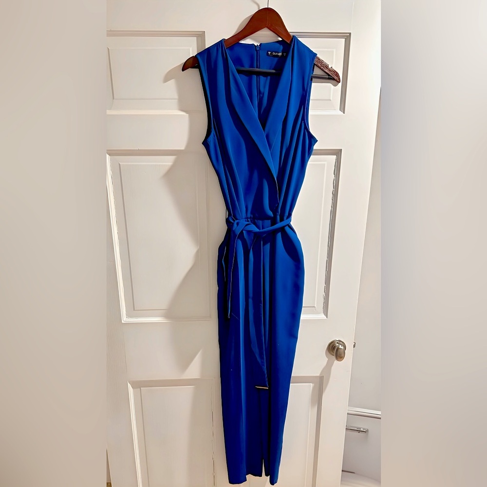 Women’s size 6/8 elegant sleeveless cobalt blue jumpsuit. Belt, back zipper.